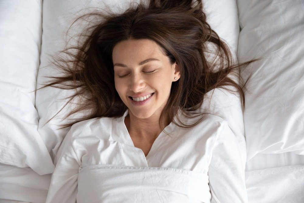 A woman sleeping on her back - skin care solutions 