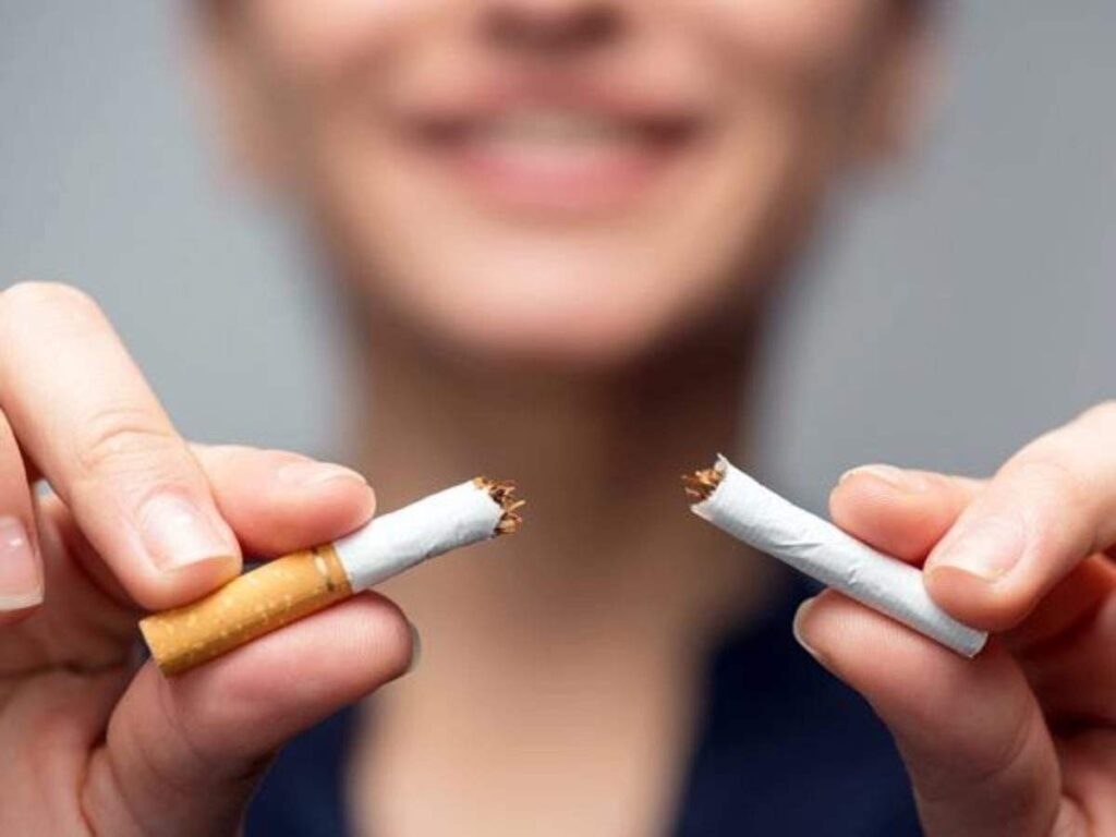 a woman breaking a cigarette in half  - skin care solutions