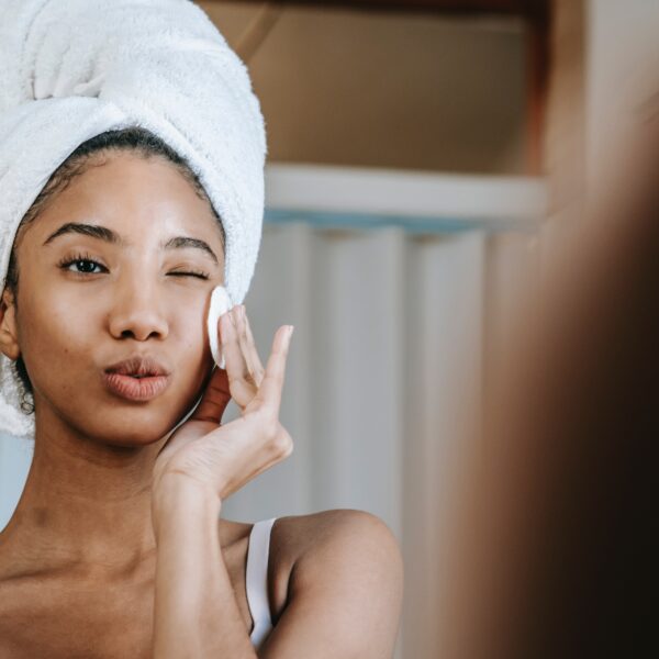 A woman applying Physio Radiance combo skincare by QNET