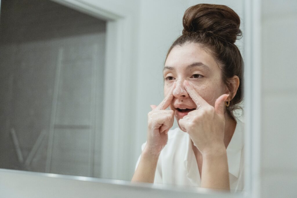 A woman applying Physio Radiance's skincare products.